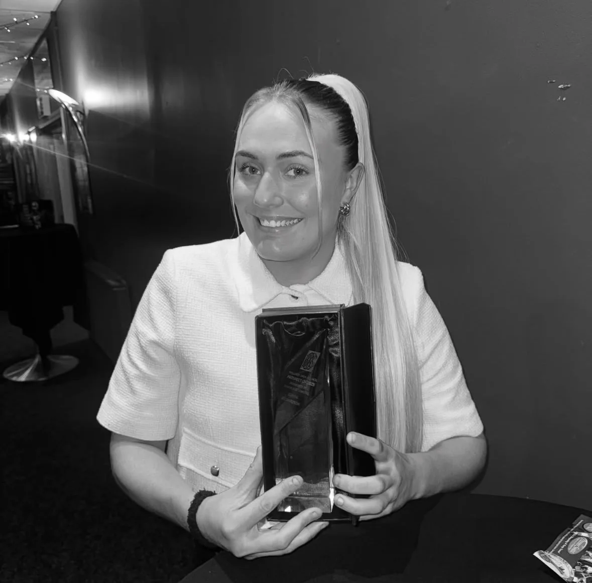 Gemma holding an award